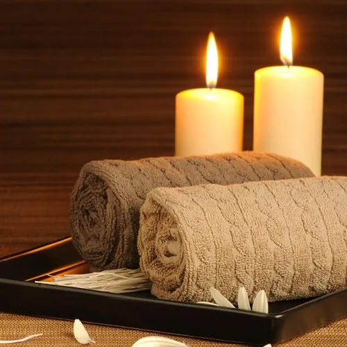 Warm towels and candles spa setup